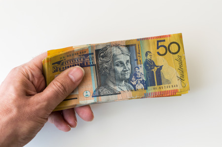 Man holding fifty Australian Dollar banknote in his handsの写真素材