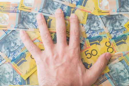 Man's hand on Australian Dollar banknoteの写真素材