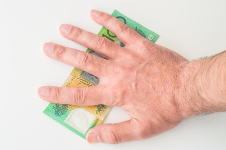 Man's hand on Australian Dollar banknoteの写真素材