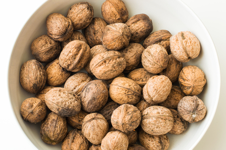 Walnuts in shell on a white background