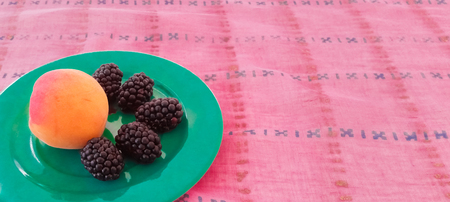 Black Mulberries With Peach in a Plateの写真素材