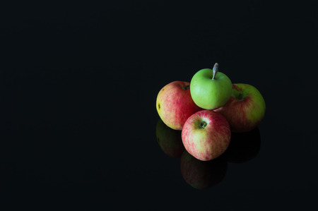 Group of fresh organic apples on a black backgroundの写真素材