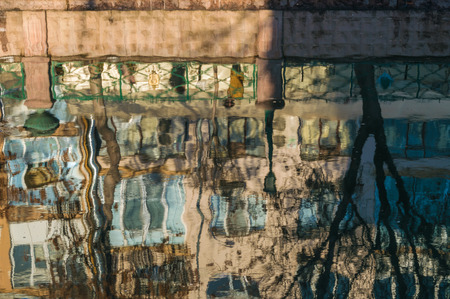 Reflections of buildings and trees in river surface in Eskisehir city in Turkey