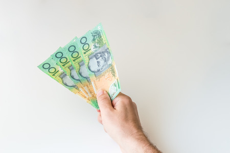 Man holding four hundred Australian Dollar banknotes in his handの写真素材