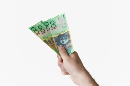 Man holding four hundred Australian Dollar banknotes in his hand