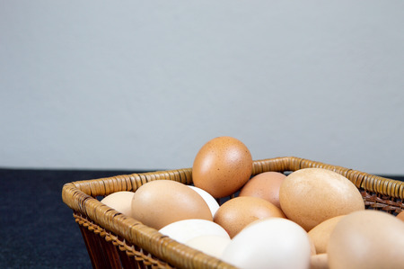 Close up of hen eggs in a basket on the table