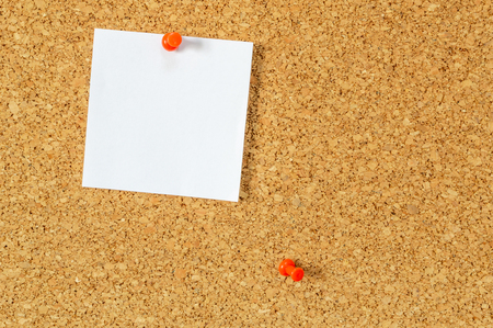 Cork board with pinned blank notepaper.の写真素材
