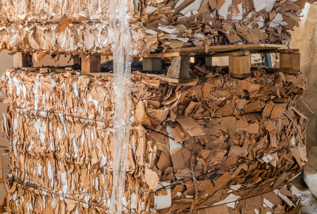 Stack of pressed corrugated cardboards ready for recyclingの写真素材