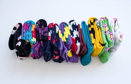 Several colorful cotton socks rolls on white background.