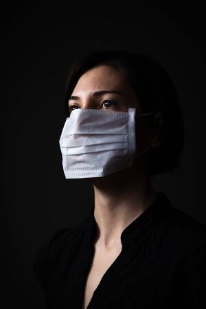 Adult woman wearing hygienic mask to prevent infection, airborne respiratory illness such as fluの写真素材