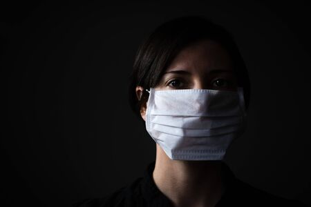 Adult woman wearing hygienic mask to prevent infection, airborne respiratory illness such as fluの写真素材