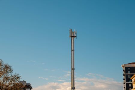 Telecommunication tower antenna on blue sky background