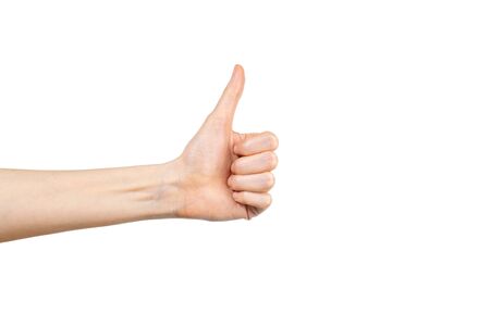 Caucasian woman hand with thumb up isolated on white background. Winner gesture. Approval concept.の写真素材