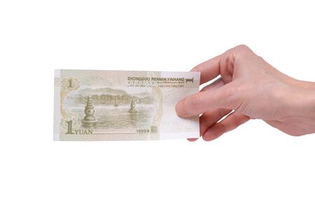 Female hand holding a 1  Chinese Yuan banknote isolated on a white background. Denomination of 1 Yuan.の写真素材