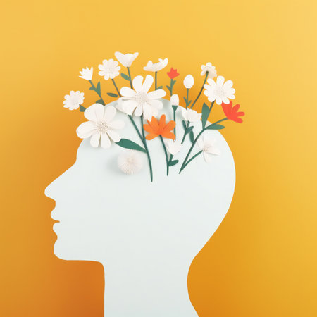 Silhouette of a human head with flowers in it over yellow background. World Mental Health Day concept.の素材