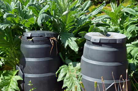 Composting bins in green garden