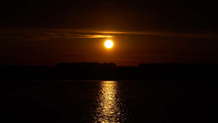 sunset and its reflection in the waterの写真素材