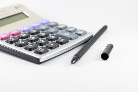 Calculator and pen on white backgroundの写真素材