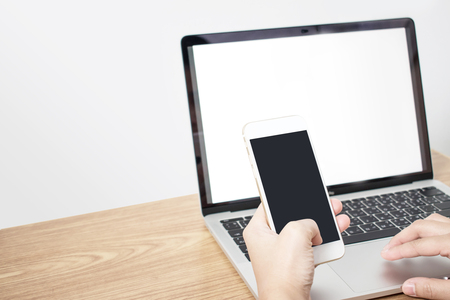 People are working on holding a phone on a wooden desk. Concept Technology.の写真素材