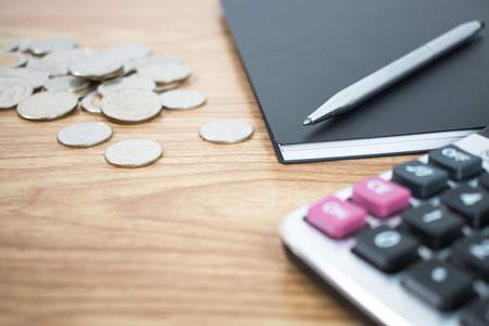 Close up the coin and put a pen on the desk of a businessman. Business Concepts.の写真素材