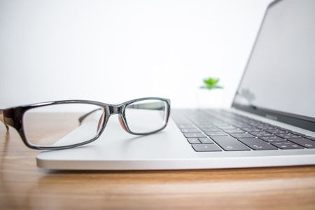 Close up. Eyeglasses of a businessman on a computer in the office.