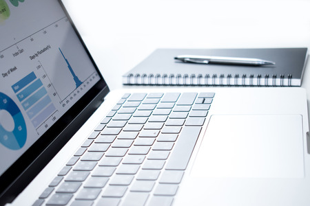 Computer monitors contain information about business finance. On the white desk. Background.