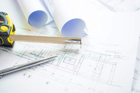 Close-up shots of the architect's office with blueprint architectural projects, pens, measuring tape and ready-to-use paper.の写真素材