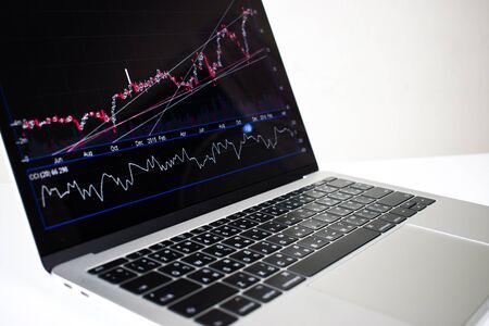 Close-up, Laptop computer image showing financial graph on screen with isolated on white background.の写真素材
