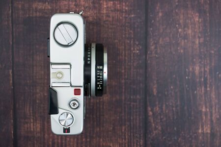 Flat lay of vintage camera on an old wooden background. Isolated background. Top view.の写真素材