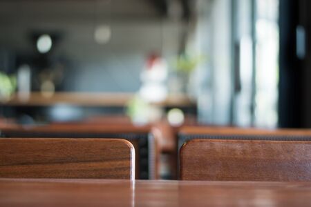 An old wooden table in a coffee shop. Blur with copy space