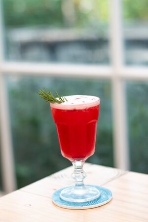 Close-up strawberry juice on a wooden table near the window.の写真素材