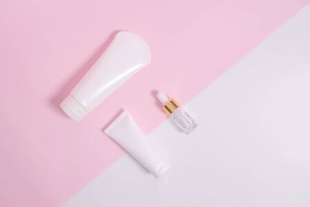 Cosmetics and serums on a white and pink background.の写真素材