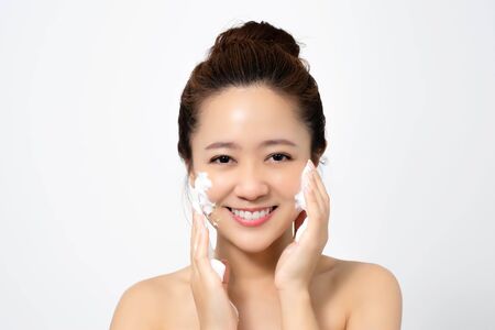 Asian women are using foam to wash face in the studio.の写真素材