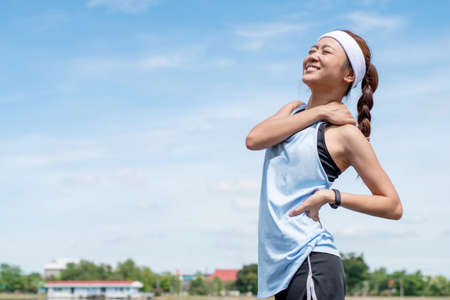 Asian women runners smile warm-up in the morning.