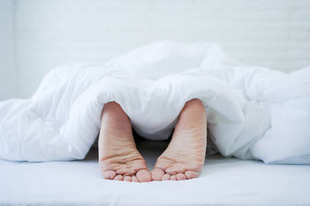 Close-up of the foot in the prone position on the bedの写真素材