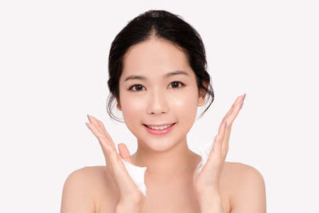 Asian women are going to use a facial foam to wash cosmetics off the face on a white background.の写真素材