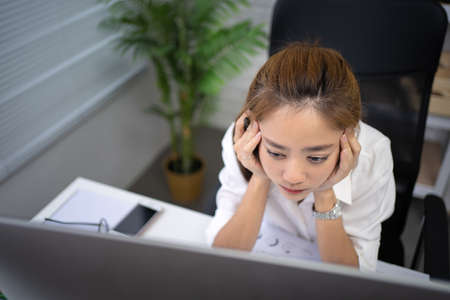 Business woman stress from work, she was tired of working in the office.の写真素材