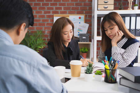 Asian groups are brainstorming reviewing lessons in the university.の写真素材