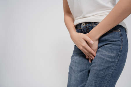 Asian woman having menstrual pain on a white background. Pain in a waman's body.の写真素材