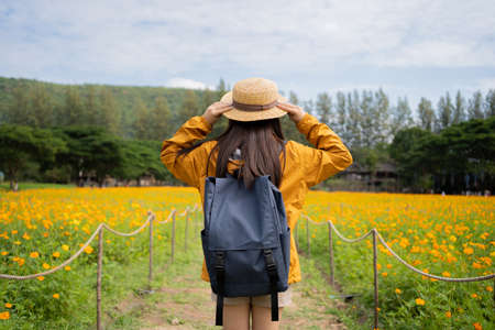 Asian woman tourist traveling alone in the flower fields.