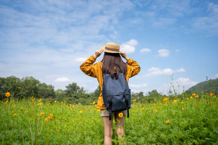 Young Asian women tourists relax in flower fields. She is traveling aloneの写真素材