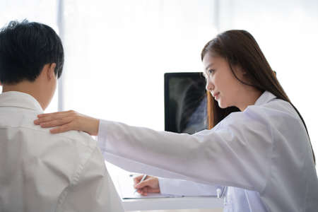 Woman doctor was explaining to the patient and she encouraged the examinations and X-rays.