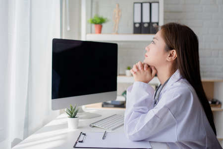 The doctor was sitting thinking something in room.の写真素材