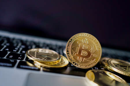 Photo Golden Bitcoins On laptop. Trading Concept Of Crypto Currency.