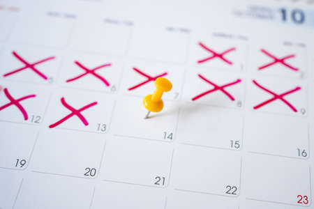 Yellow pin on the calendar on the 14th with selectable focus.の写真素材