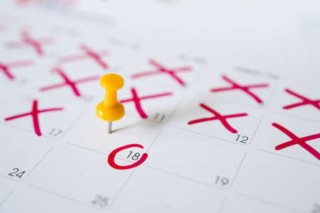 Calendar with yellow pins on May 18. Reminder or deadline concept.の写真素材