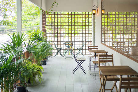 Green cafe with hydroponic plants in front of the building.