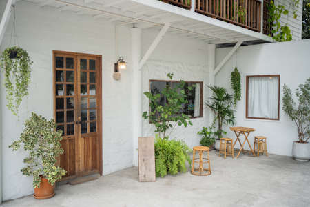 Tropical style home decoration like in nature. A photograph of the front of the house decorated with a wall of treesの写真素材