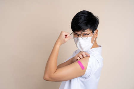 Smiling happy Asian people after shot receive covid-19 anti virus vaccine in campaign vaccination.の写真素材