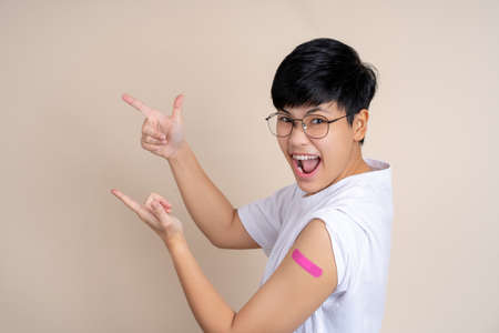 Happy asian people smiling after receiving vaccination, with copy space.の写真素材